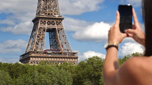 Cropped View Of A Woman Taking Photo Of Eiffel Tower Using Cellphone In Paris, France.