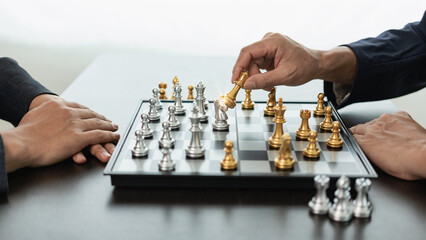 A smart businessman plays a game of chess with the opposing team. Plan business strategies to...