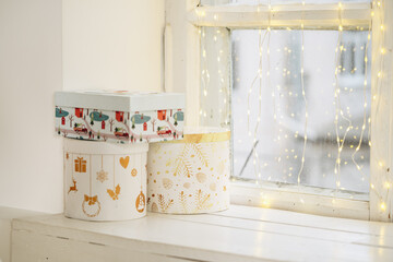 Stack of presents placed on decorated windowsill