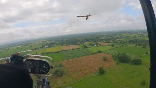 POV of ultralight plane gliding across down to the ricefield