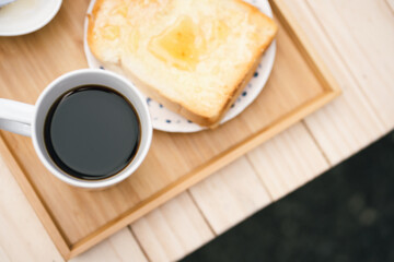 people activity concept with top view of breakfast with black coffee and bread put on wood table