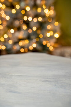 Vintage wooden table wit Christmas bokeh lights.