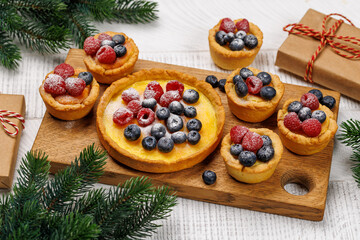 Naklejka na ściany i meble Christmas cupcakes adorned with berries