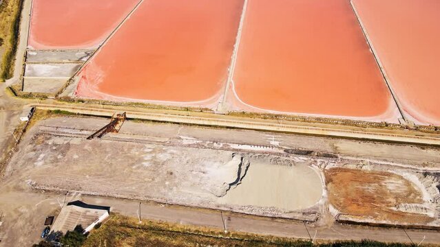 Aerial shot of Mounds of dried salt in evaporated salt pond in sea saltern in Turkiye