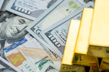 USD 100 dollar banknotes with gold bars as saving background. Rich, wealth and financial concept