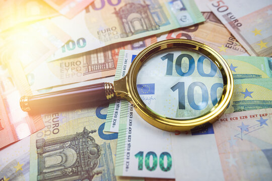  magnifying glass above euro banknote as finance background