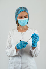 Female doctor in a mask gloves hold syringe with vaccine isolated on white.