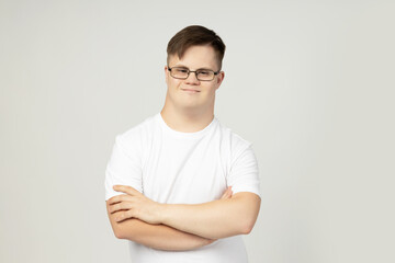 PNG,smiling young man with down syndrome in a white t-shirt poses for the camera,isolated on white background