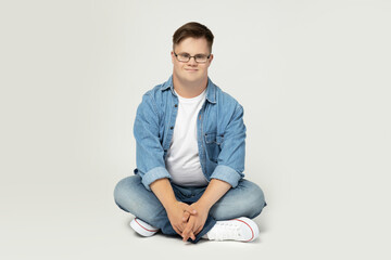 PNG,smiling young man with down syndrome in glasses, jeans and white t-shirt posing for...
