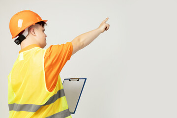 PNG, boy with down syndrome in work uniform with hard hat on his head, isolated on white background