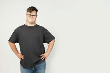 PNG, a boy with down syndrome in a black t-shirt posing for the camera, isolated on a white...