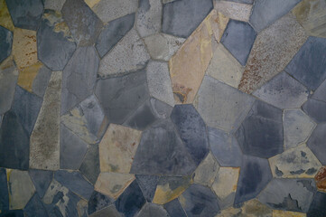 Closeup of Layered stone wall texture background for design and decoration in Thailand.