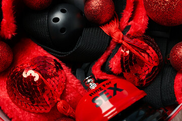 Sex toys with Christmas decorations on a dark background.