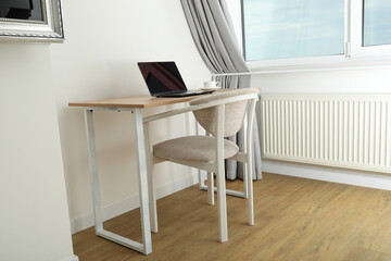 A cup of coffee and a laptop on the table