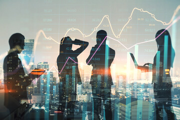 Silhouettes of traders on stock market background