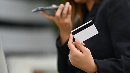 Modern businesswoman talking on mobile phone with bank client support operator