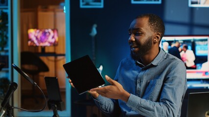 African american technology internet star filming review of newly released graphic tablet, greeting...