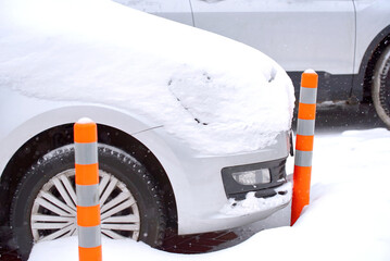 Car bump flexible plastic bollard while parking on parking lot in winter. Flexible traffic bollard....