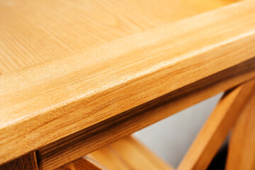 Fragment of wooden furniture. A product made from natural materials with a textured effect. Close-up. Selective Focus