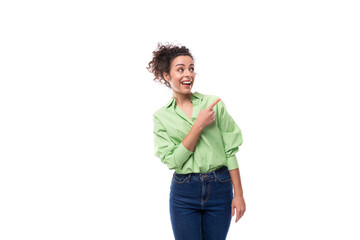 portrait of a young charming brunette businesswoman with curly hair gathered in a bun dressed in an office light green shirt on a white background with copy space