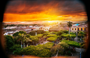View of the central park of Granada at sunset. Beautiful view of central park of Granada from the viewpoint. Tourist places in Granada, Nicaragua - obrazy, fototapety, plakaty