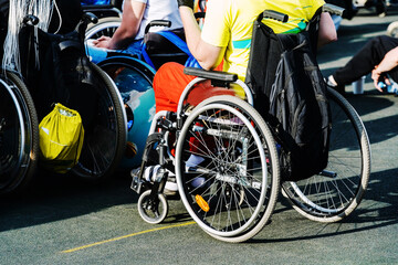 A disabled person in a wheelchair on an excursion walk. Close-up. Unrecognizable man