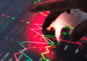 Trader analyzing financial performance data on screen