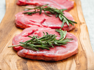 Fresh juicy boneless lamb steak on a wooden board. Premium meat product for cooking. High quality meat cut. Food chain.