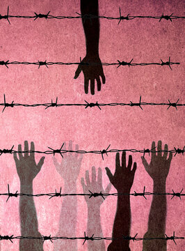 Hands of people reaching towards barbed wire