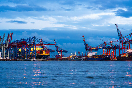 Germany, Hamburg, Container terminals Burchardkai and Eurogate in Port of Hamburg at dusk
