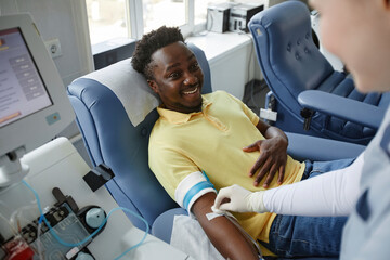 Smiling donor talking to healthcare worker at blood donation center