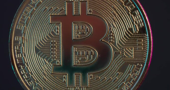 Bitcoin coins rotate around their axis in smoke.