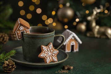 Cup of hot chocolate with gingerbread cookies and house