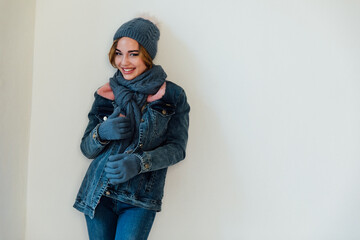 Beautiful woman in winter clothes on white background