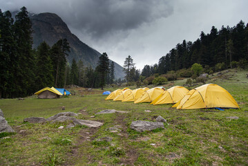 
A group of tents in a the mountains