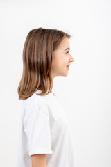 Brunette girl smiling with braces on her teeth on a white background isolated.