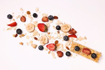 Tasty granola bar and ingredients isolated on white, top view