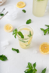 Lemonade with mint on a white background. Cool drink with lemon and mint.