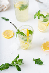 Fototapeta premium Lemonade with mint on a white background. Cool drink with lemon and mint.