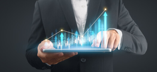 Businessman plan graph growth and increase of chart positive indicators,tablet in hand
