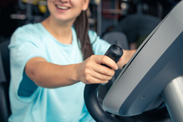 Fitness woman on bicycle doing cardio workout at gym.