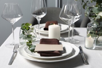 Beautiful table setting with card and floral decor