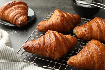 Delicious freshly baked croissants on grey table