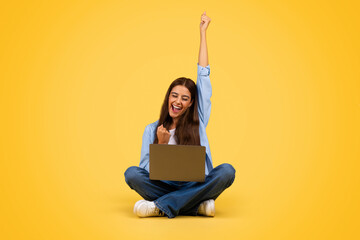 Cheerful young european student woman with laptop, rise hand up