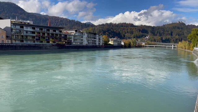 Kufstein river and residential buildings on sunny day in Austria. Natural panoramic views of European city