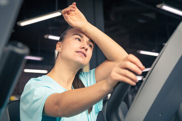 Fototapeta na wymiar Fitness woman on bicycle doing cardio workout at gym.