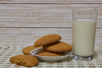 cookies with a glass of milk,a plate with cookies and a glass of cow's milk for children