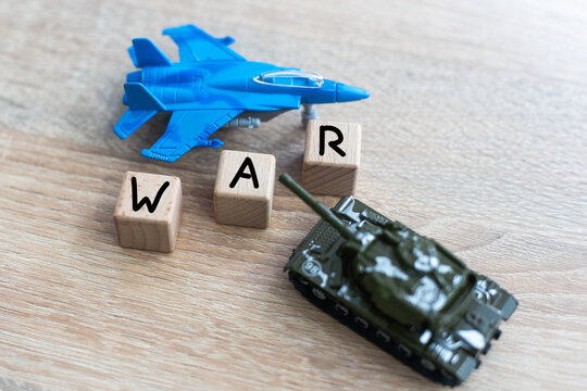 The image shows models of tanks and fighter jets on a white background, close up.