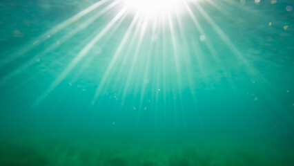 Fototapeta na wymiar Underwater view of the sea surface with sunbeams and lens flare