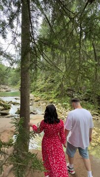 romantic couple at the edge of mountain river